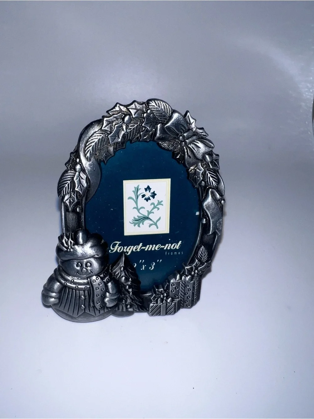 Small pewter-style Christmas picture frame featuring a smiling snowman